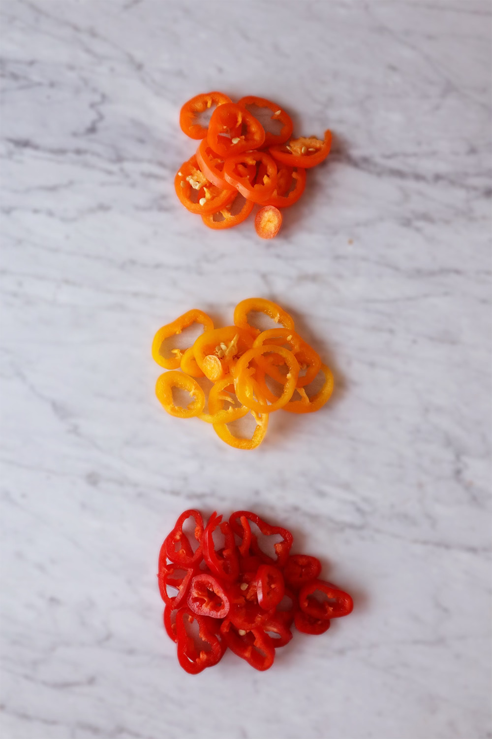 Sliced mini bell peppers in red, orange, and yellow
