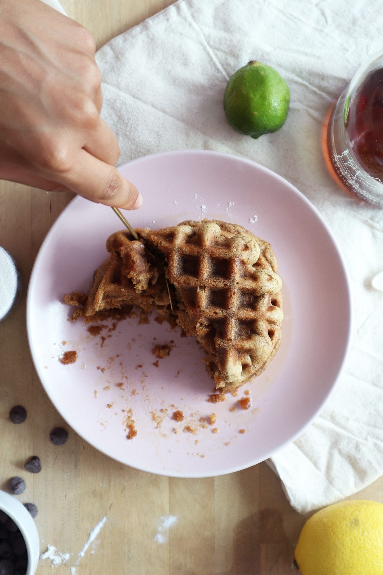 Cutting into a stack of vegan waffles with a fork